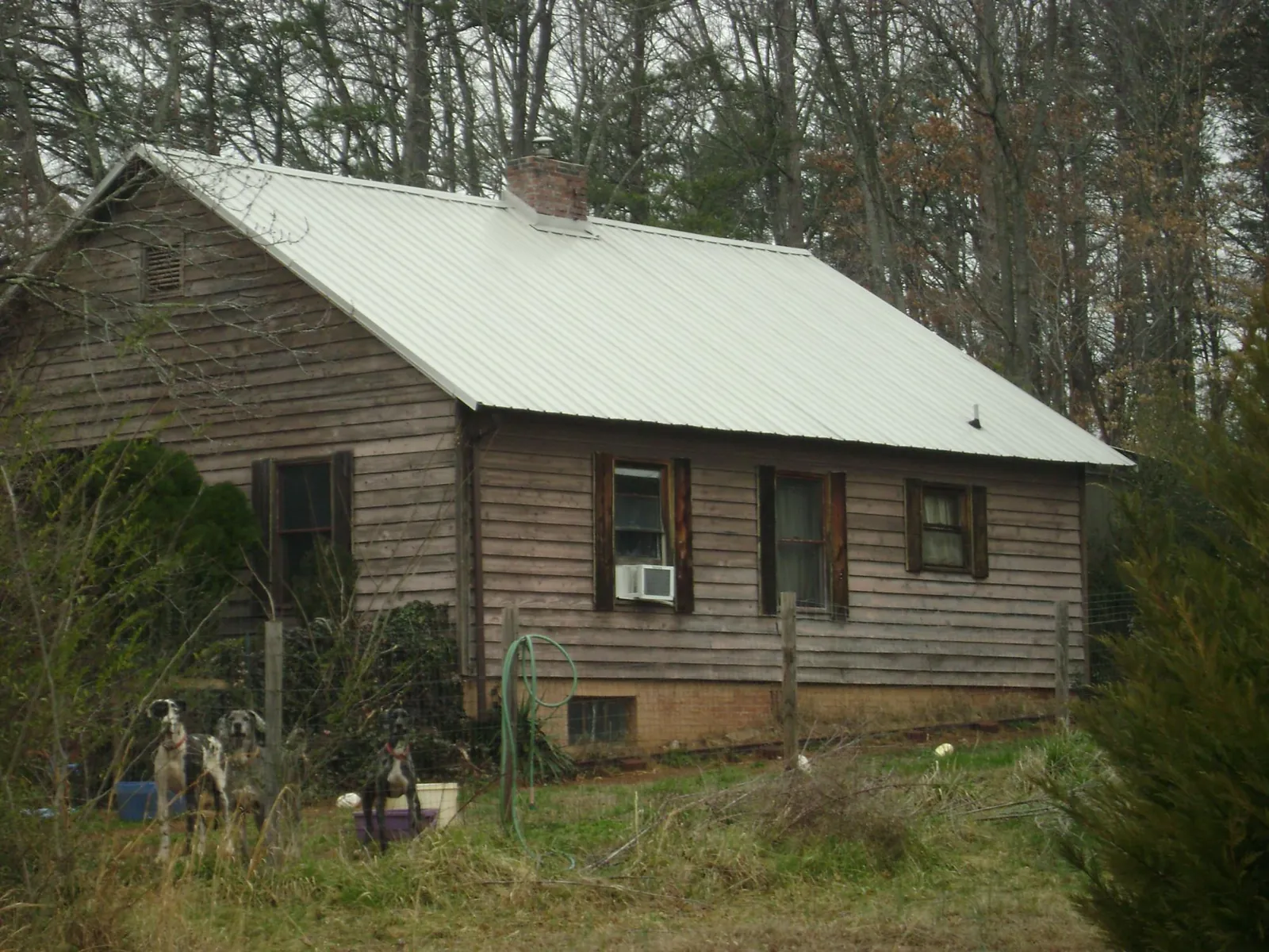 White metal roof on an old wood sided farmhouse, from a Metal Roof Installation job in Martensdale